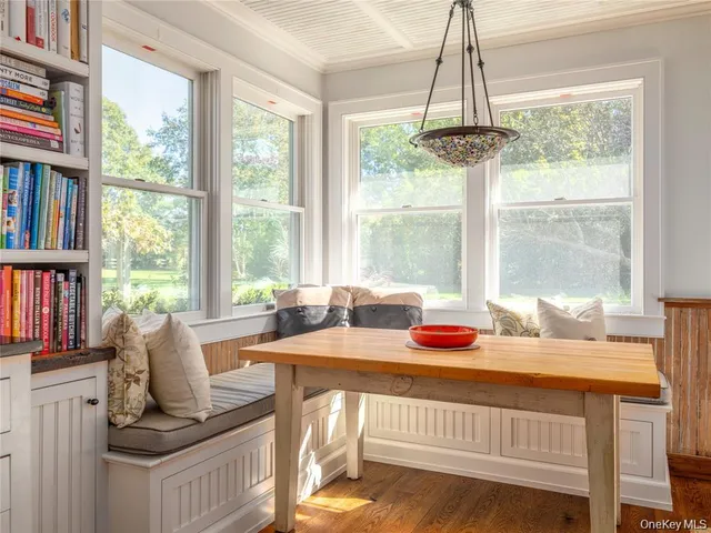 a dining room with furniture window and outside view
