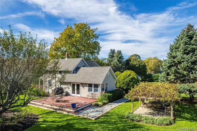 a view of a house with pool and garden
