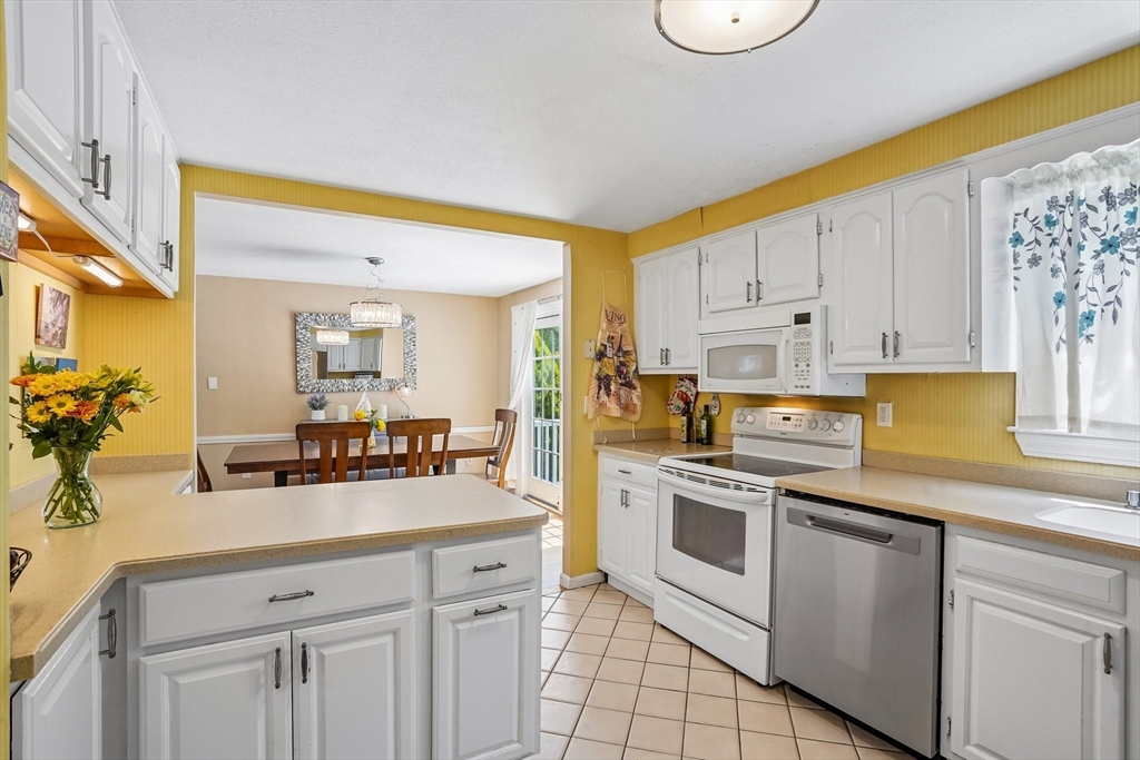 35 Westgate Road Framingham, MA 01701 - Photo 13 of 37 a kitchen with white cabinets and appliances