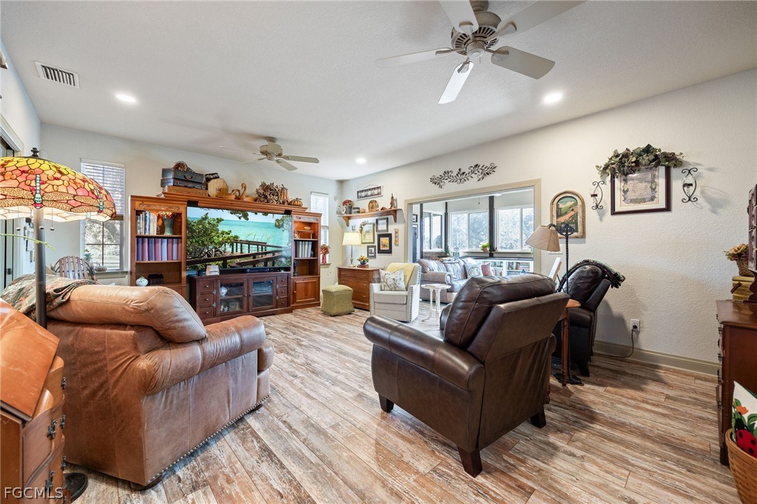 22800 North River Road Alva, FL 33920 - Photo 13 of 50 a living room with furniture and a fireplace