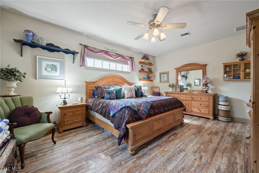 22800 North River Road Alva, FL 33920 - Photo 17 of 50 a bedroom with a bed and wooden floor