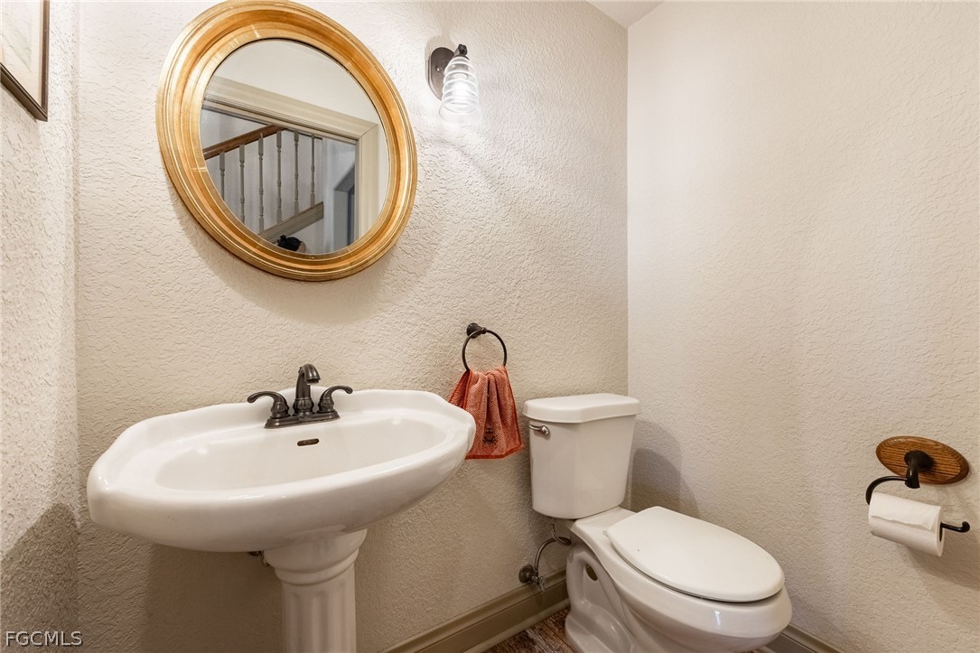 22800 North River Road Alva, FL 33920 - Photo 21 of 50 a bathroom with a sink a toilet and a sink