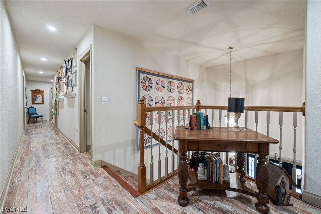 22800 North River Road Alva, FL 33920 - Photo 22 of 50 a view of a hallway with wooden floor and staircase