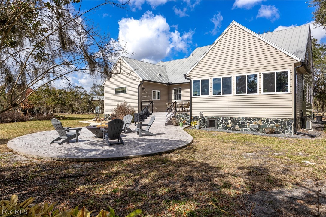 22800 North River Road Alva, FL 33920 - Photo 32 of 50 a front view of a house with a yard outdoor seating and covered with trees