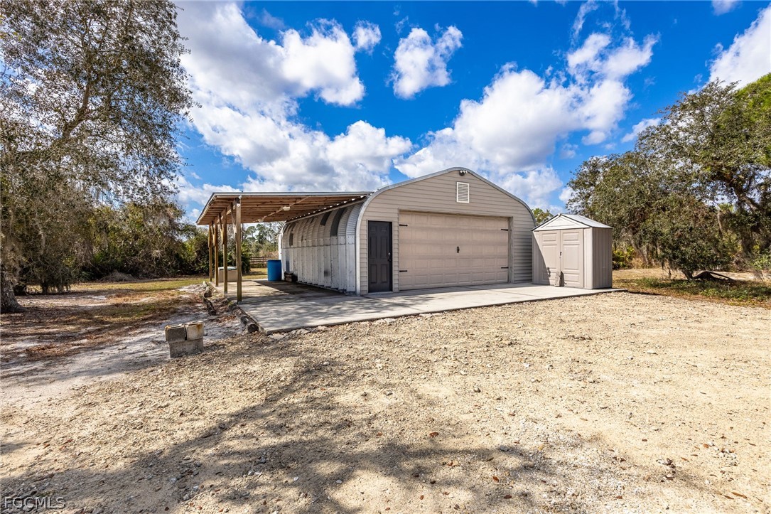 22800 North River Road Alva, FL 33920 - Photo 35 of 50 a view of a grey house with a yard
