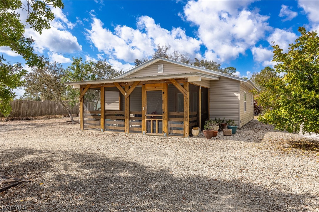 22800 North River Road Alva, FL 33920 - Photo 36 of 50 a view of a house with a large tree and a big yard