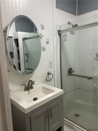 a bathroom with a sink a toilet and shower