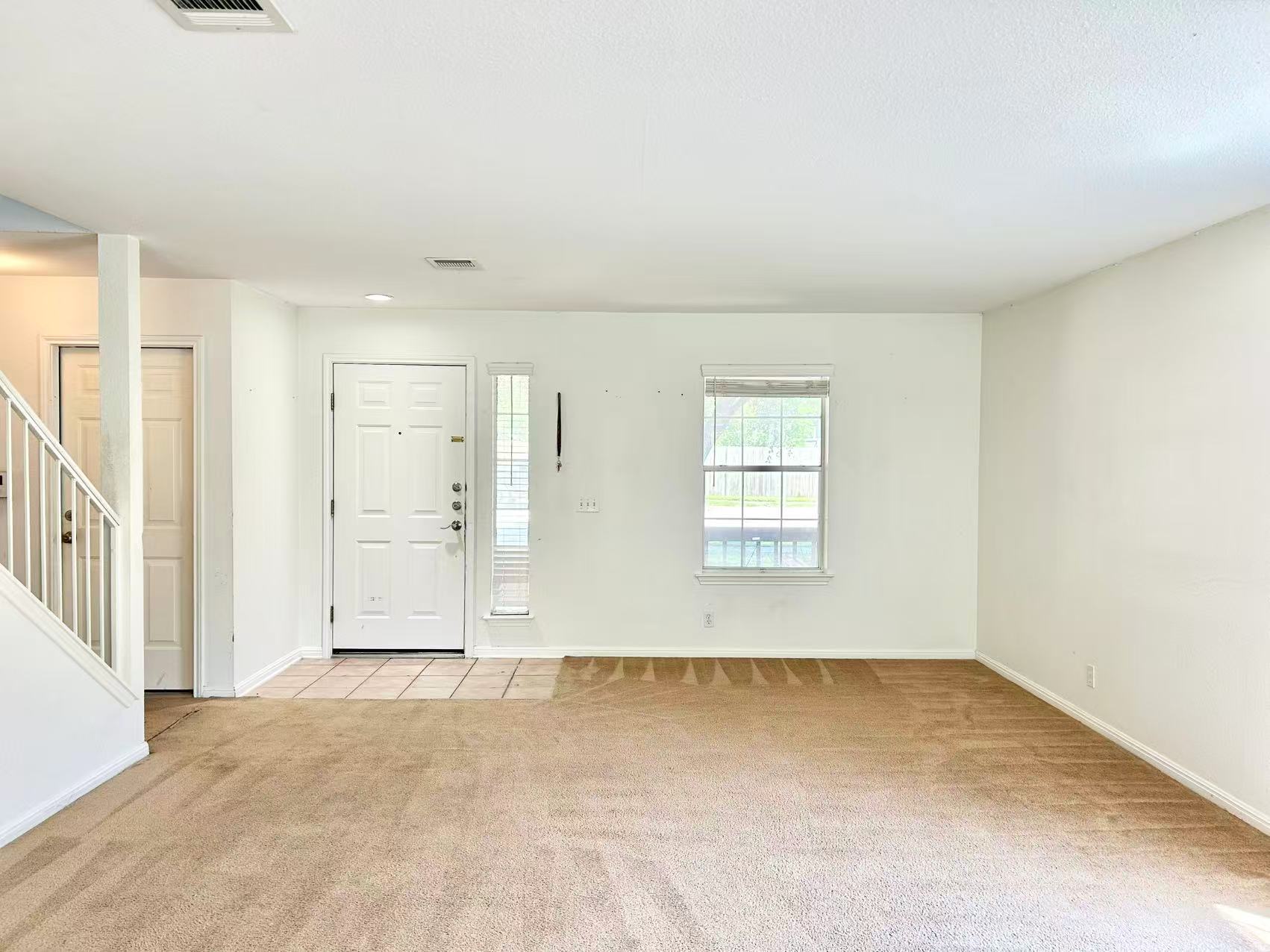 5608 Netleaf Road Austin, TX 78724 - Photo 3 of 26 A well-lit living area awaits, offering a clear view to the outside and a gracious entry.