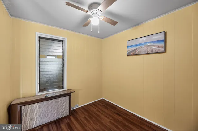 a view of a hallway with a window and a ceiling fan