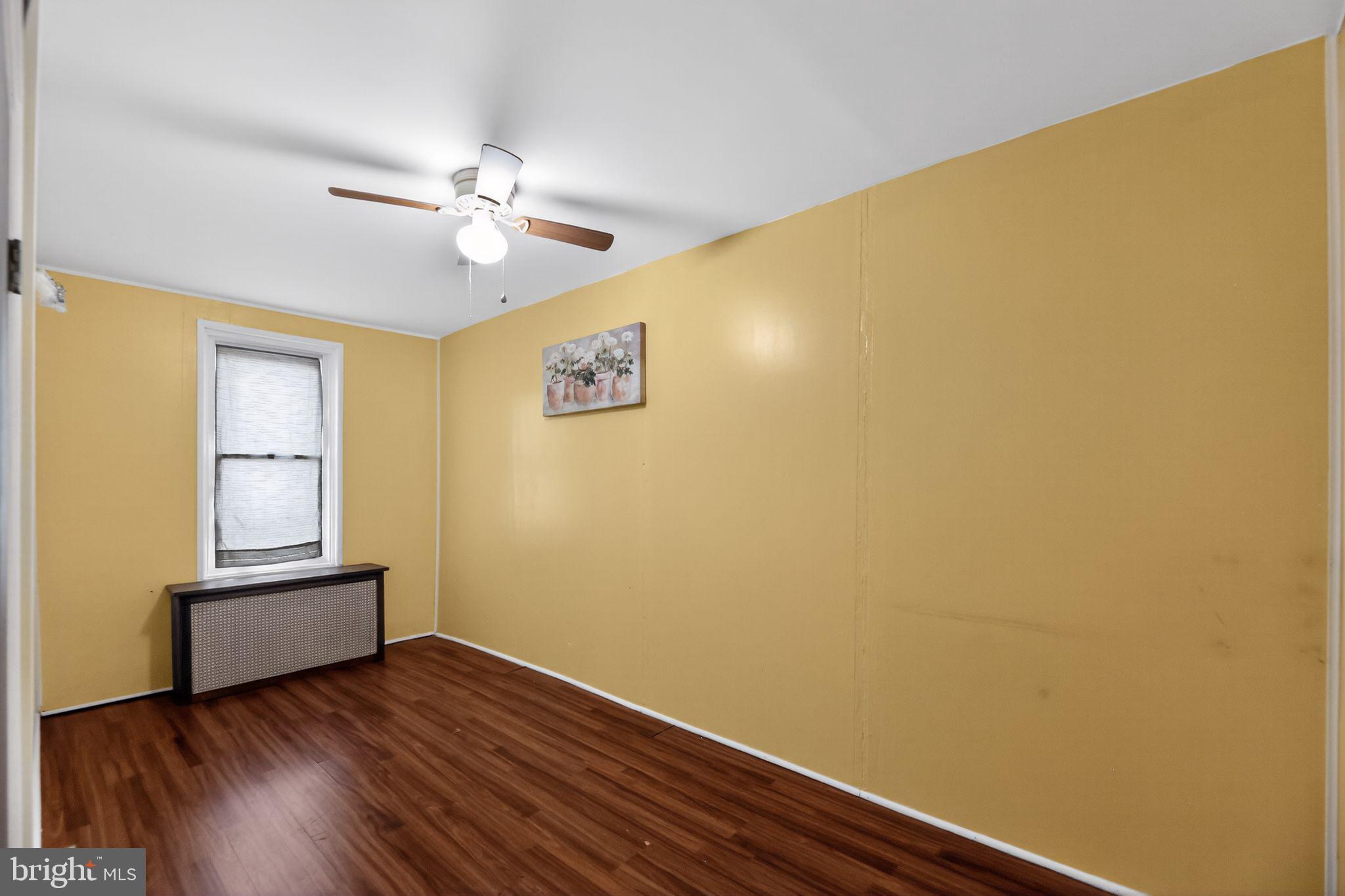 315 Fitzgerald Street Philadelphia, PA 19148 - Photo 14 of 15 a view of an empty room with wooden floor and a window