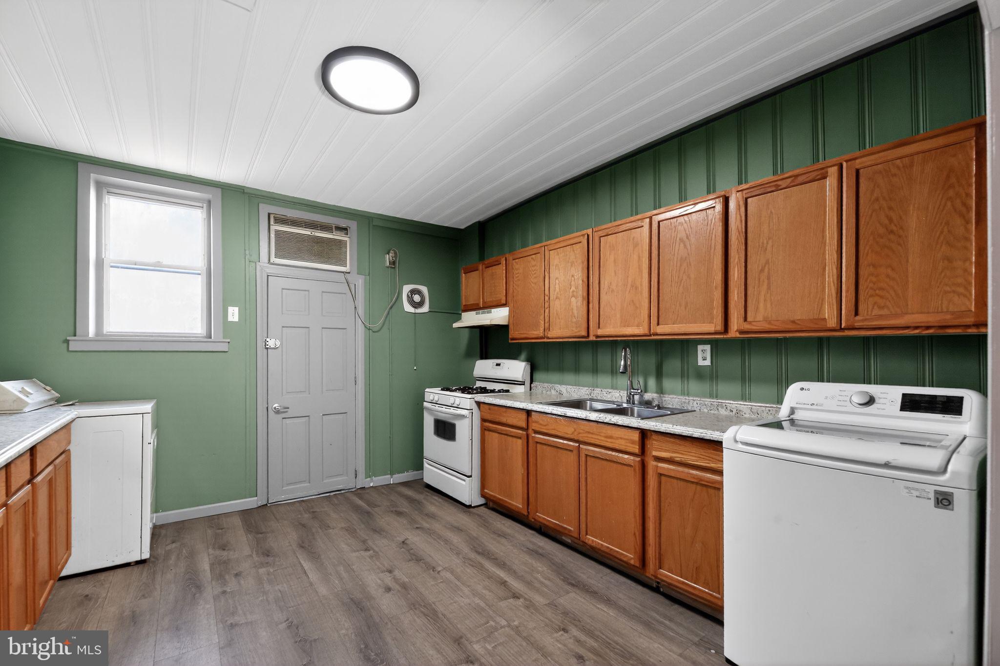315 Fitzgerald Street Philadelphia, PA 19148 - Photo 2 of 15 a kitchen with stainless steel appliances granite countertop a stove a sink dishwasher and a refrigerator