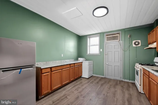 a room with wooden floor and a sink