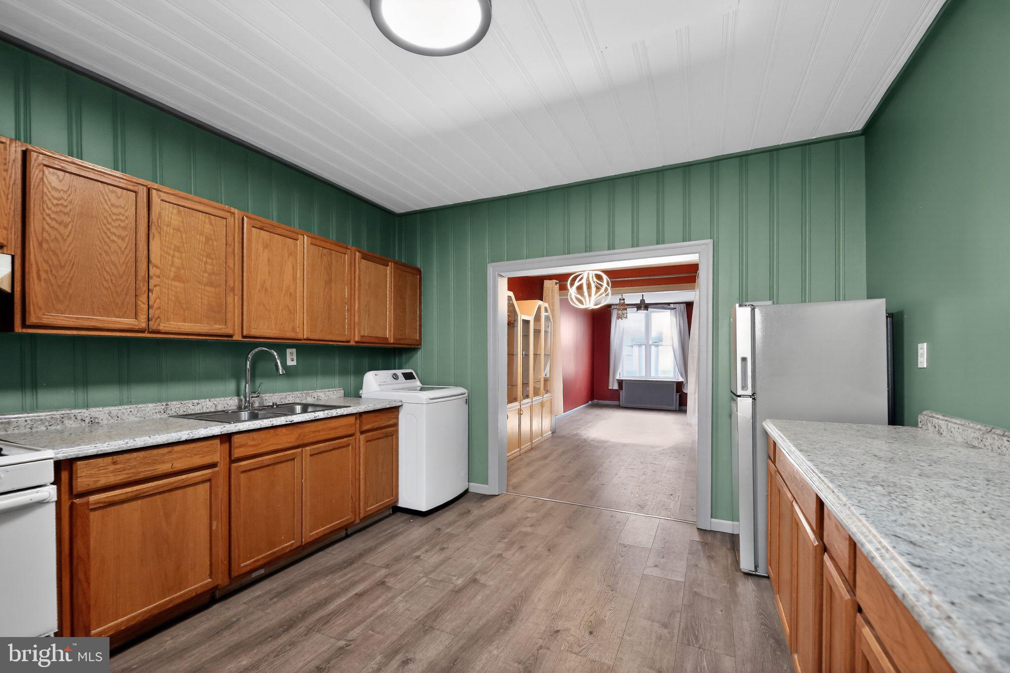 315 Fitzgerald Street Philadelphia, PA 19148 - Photo 4 of 15 a kitchen with stainless steel appliances granite countertop a sink a stove counter space and cabinets