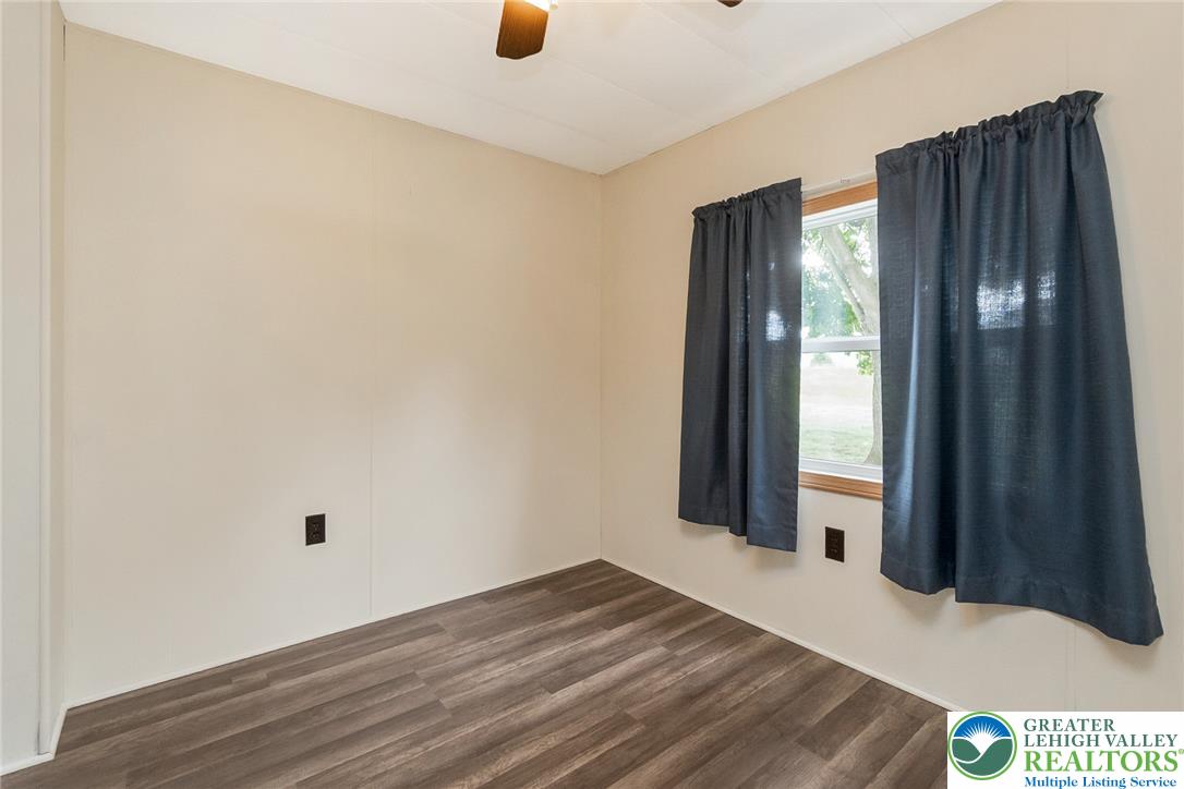 8721 Turkey Ridge Road Breinigsville, PA 18031 - Photo 20 of 30 Smooth wood-look flooring and a bright window define this versatile bedroom space.