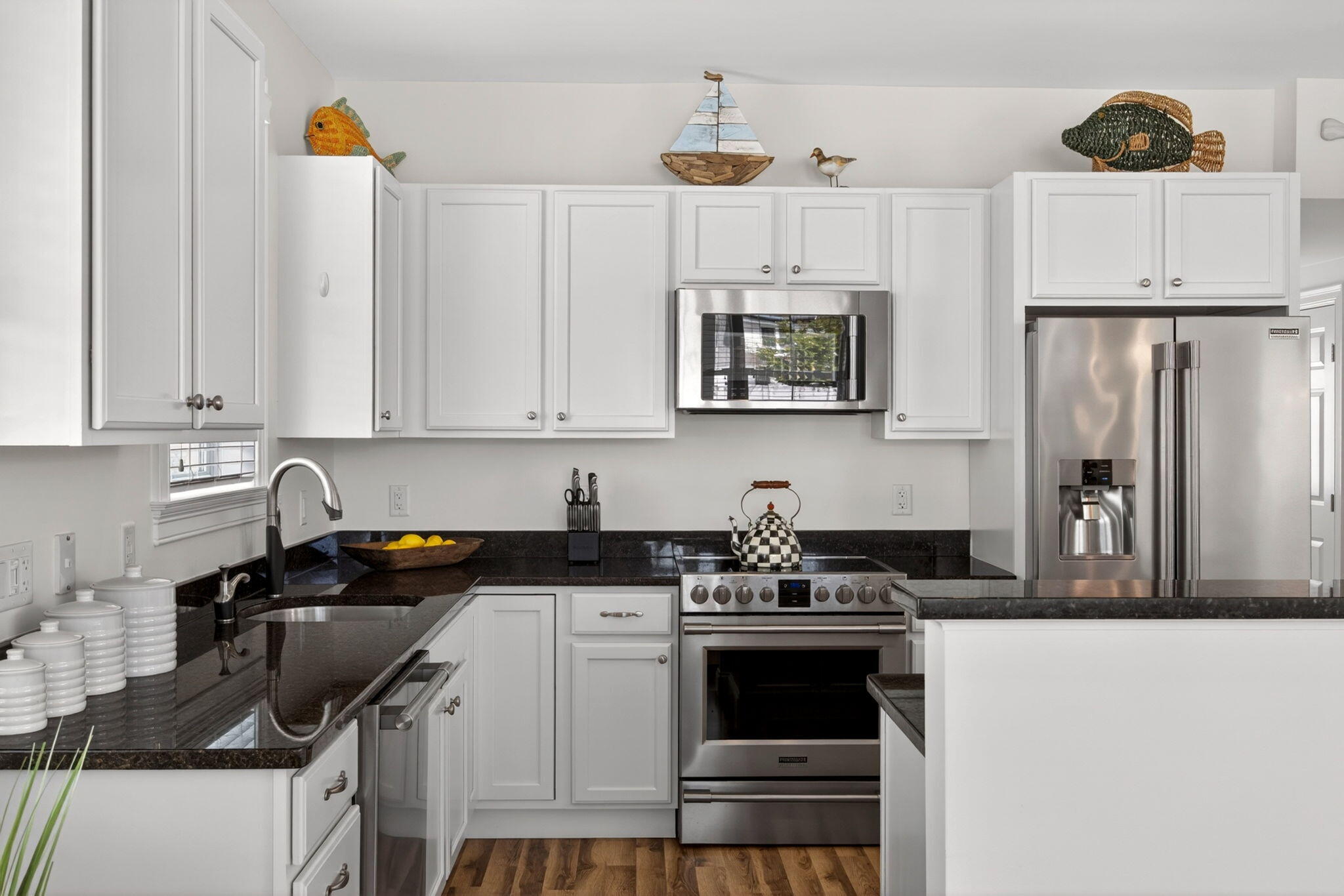 61 Old Wharf Road, Unit 62 Dennis Port, MA 02639 - Photo 22 of 45 a kitchen with stainless steel appliances a stove a sink a refrigerator and cabinets