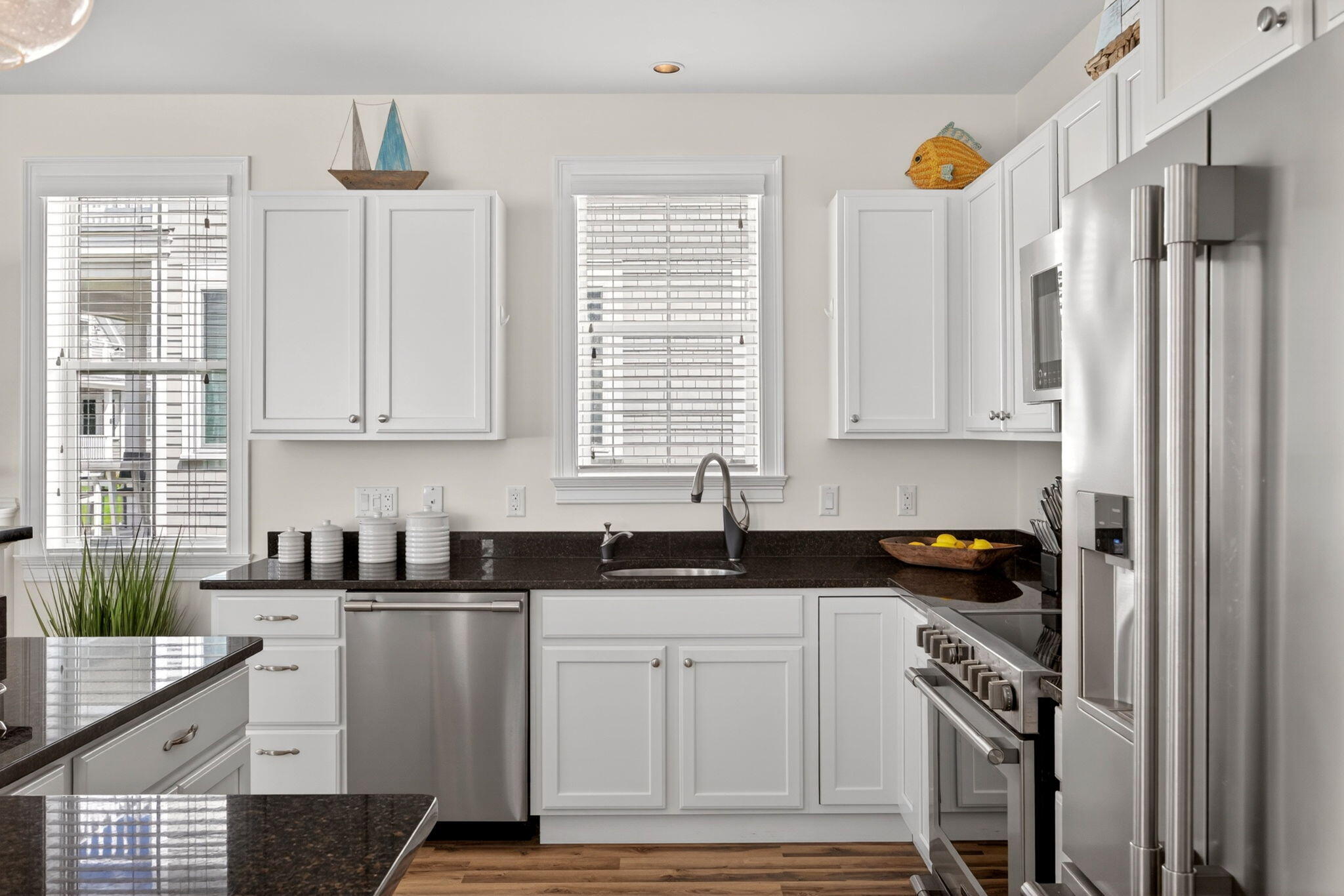 61 Old Wharf Road, Unit 62 Dennis Port, MA 02639 - Photo 23 of 45 a kitchen with granite countertop a sink cabinets and stainless steel appliances