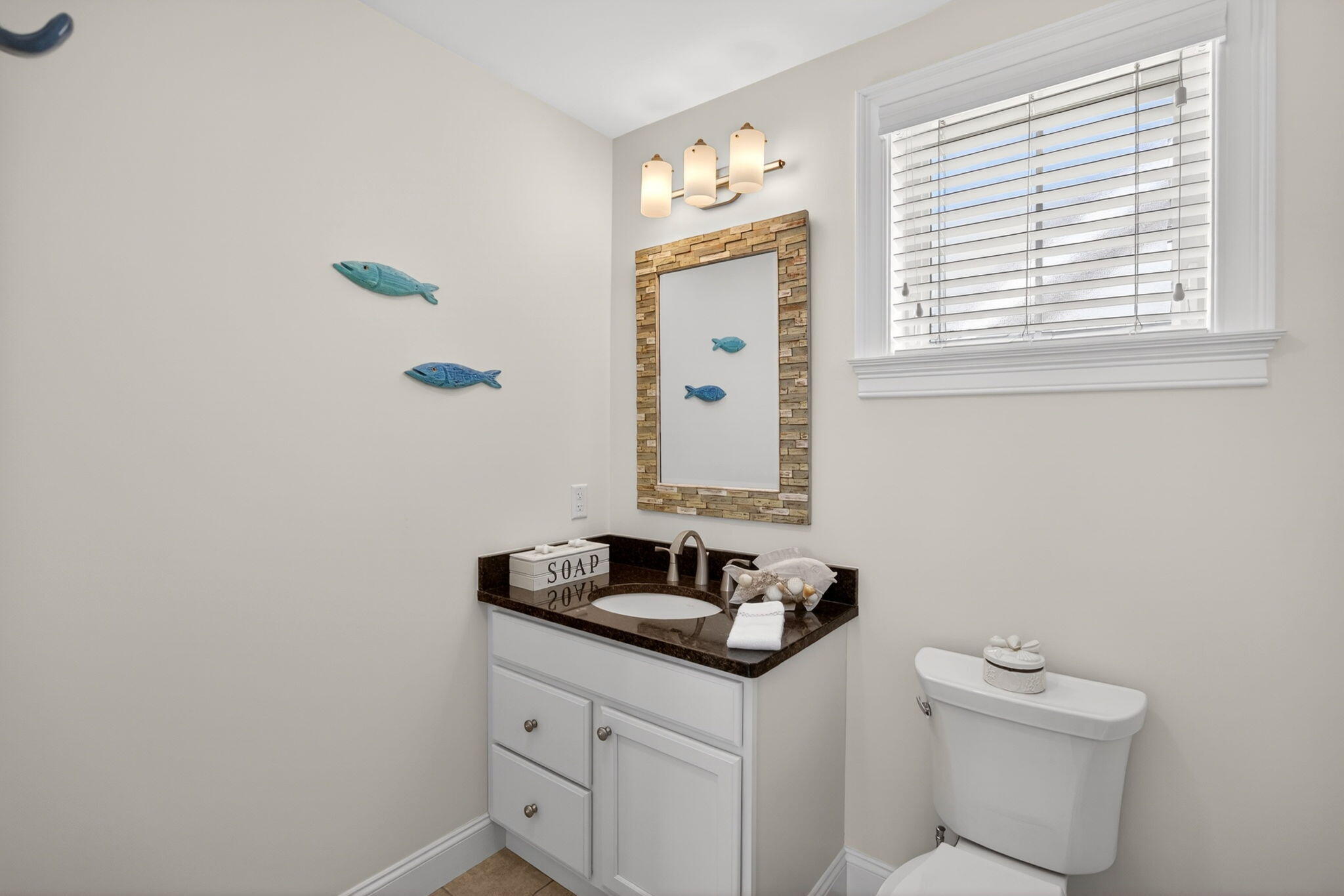 61 Old Wharf Road, Unit 62 Dennis Port, MA 02639 - Photo 29 of 45 a bathroom with a sink a toilet and a window