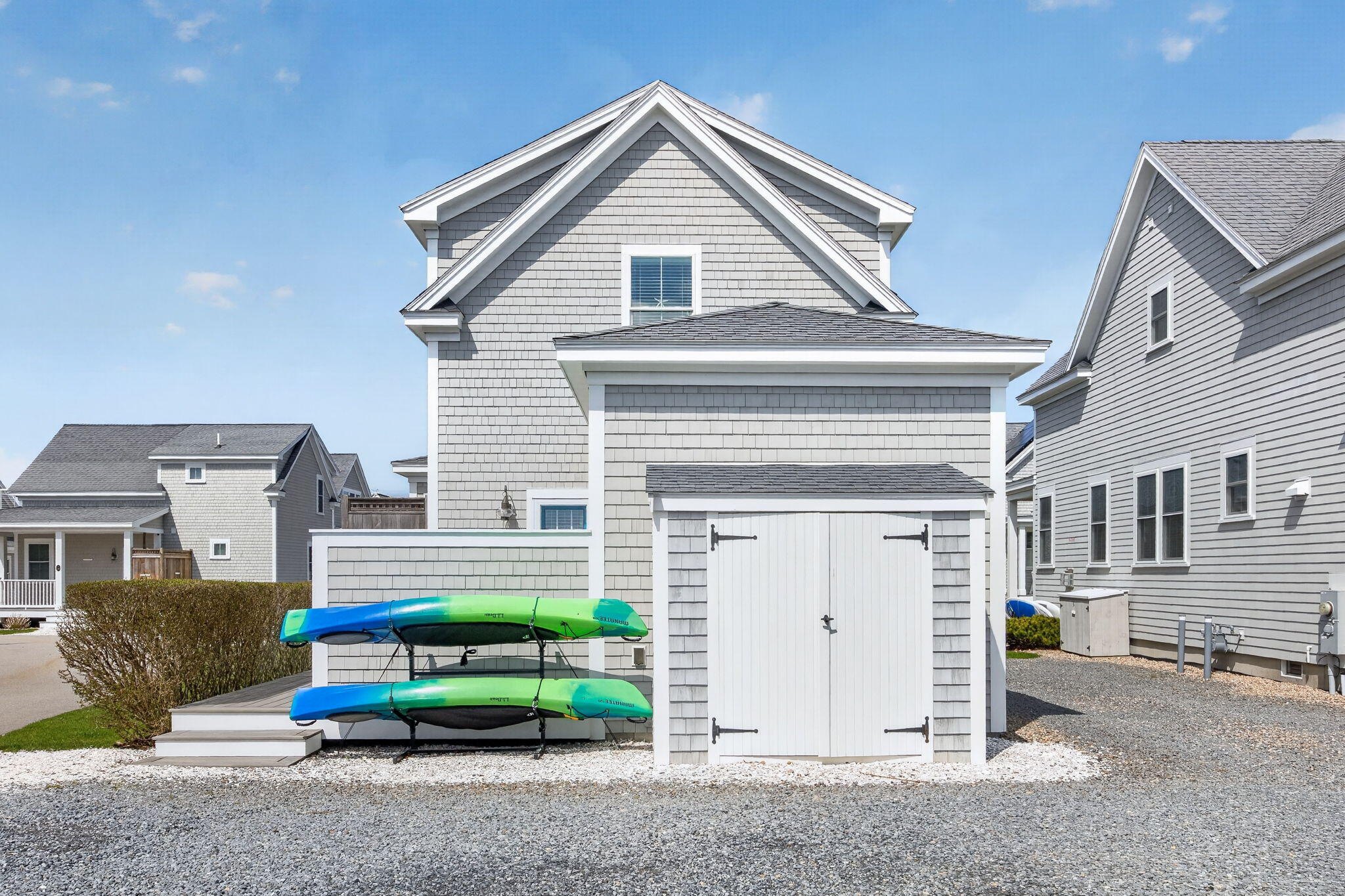 61 Old Wharf Road, Unit 62 Dennis Port, MA 02639 - Photo 6 of 45 a front view of a house with a yard and garage