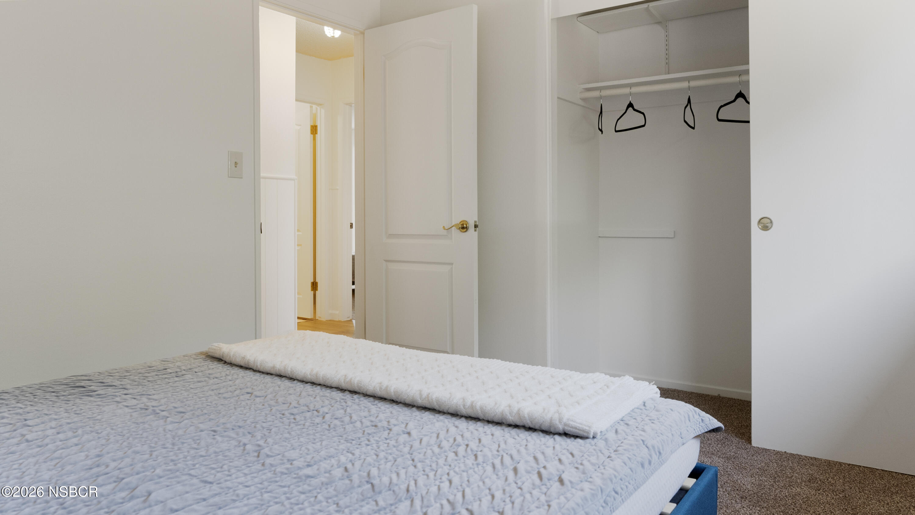 1312 North First Place Lompoc, CA 93436 - Photo 20 of 38 a bedroom with a bed and a chandelier