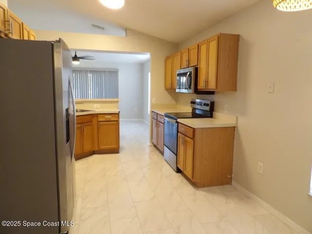 a kitchen with stainless steel appliances a sink stove and refrigerator