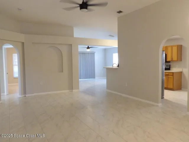 a view of a kitchen with a sink and a refrigerator