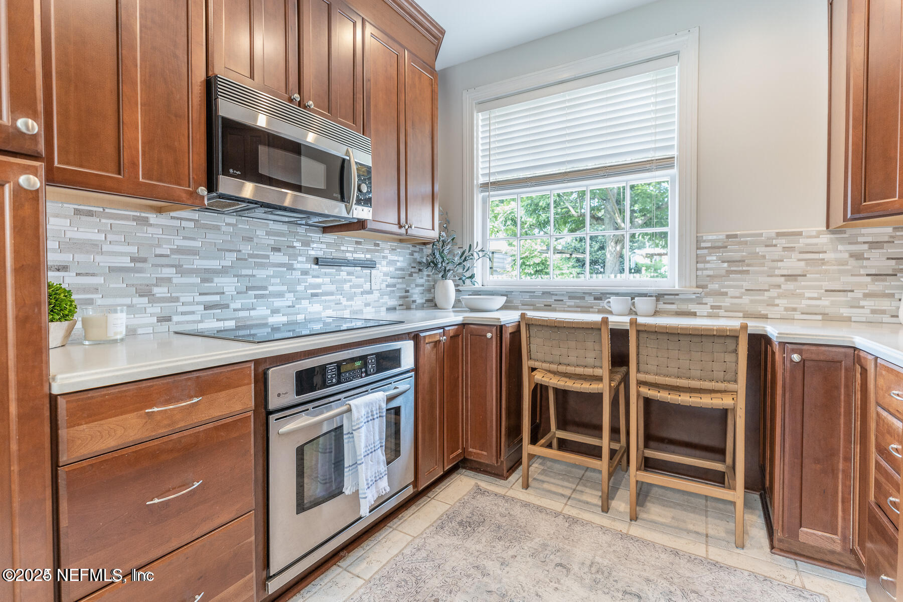 2545 Hendricks Avenue Jacksonville, FL 32207 - Photo 20 of 45 a kitchen with granite countertop a stove top oven microwave and cabinets