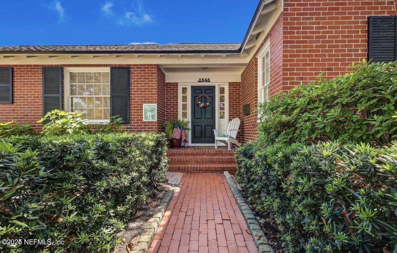 2545 Hendricks Avenue Jacksonville, FL 32207 - Photo 2 of 45 a view of a pathway both side of house