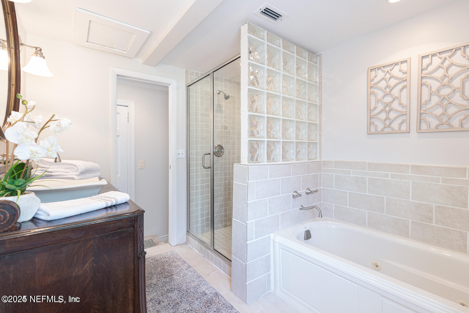 2545 Hendricks Avenue Jacksonville, FL 32207 - Photo 37 of 45 a bathroom with a bathtub sink and mirror