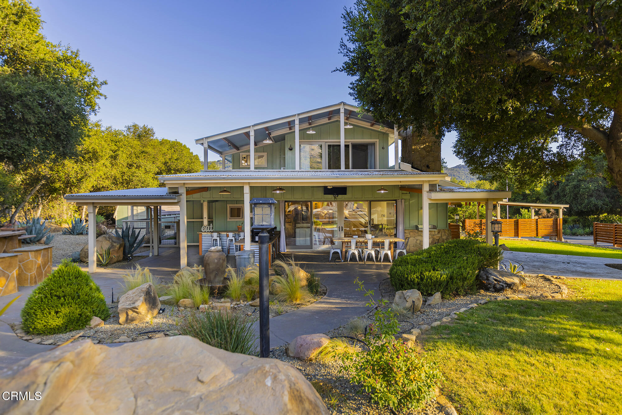12475 Christmas Tree Road Ojai, CA 93023 - Photo 26 of 50 a front view of a house with a yard table and chairs