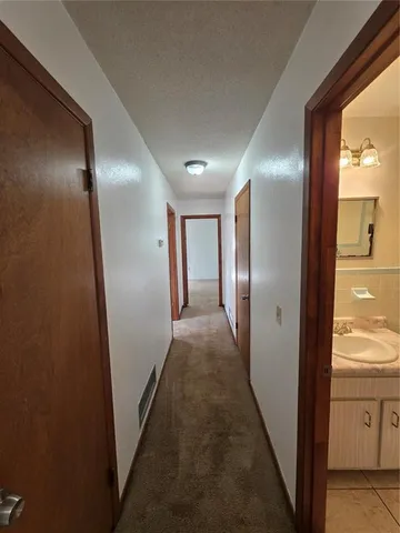 a view of hallway with wooden floor