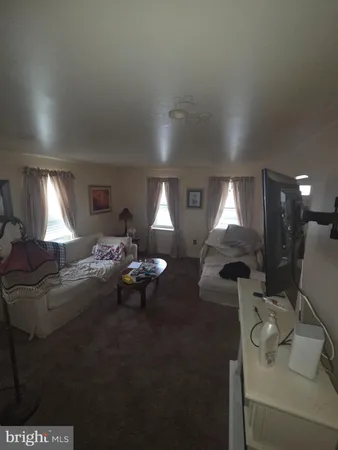 a living room with furniture and a lamp