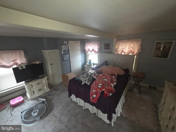 a living room with furniture a lamp and rug