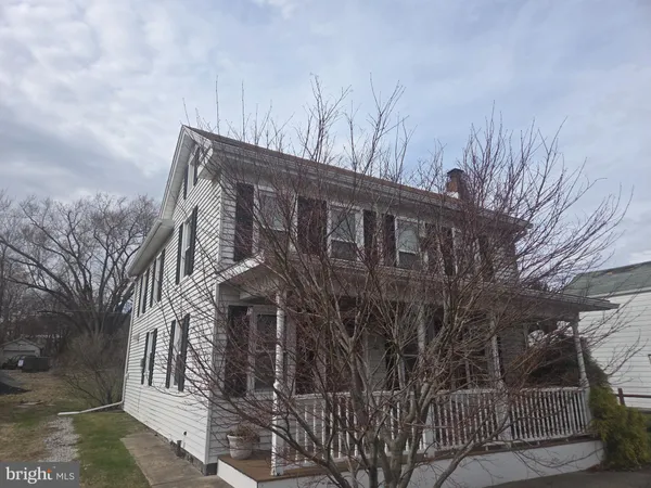 a view of a house with a snow in the yard