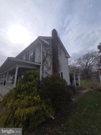 a front view of house with a garden