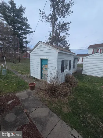 a front view of house with yard and trees