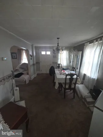a living room with furniture a window and a chandelier