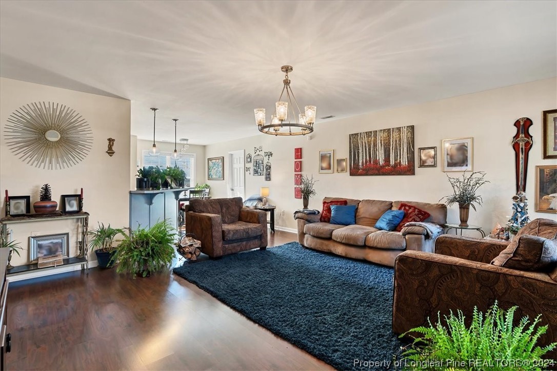 623 Hammonds Road Lumberton, NC 28360 - Photo 14 of 39 a living room with furniture a chandelier and a fireplace