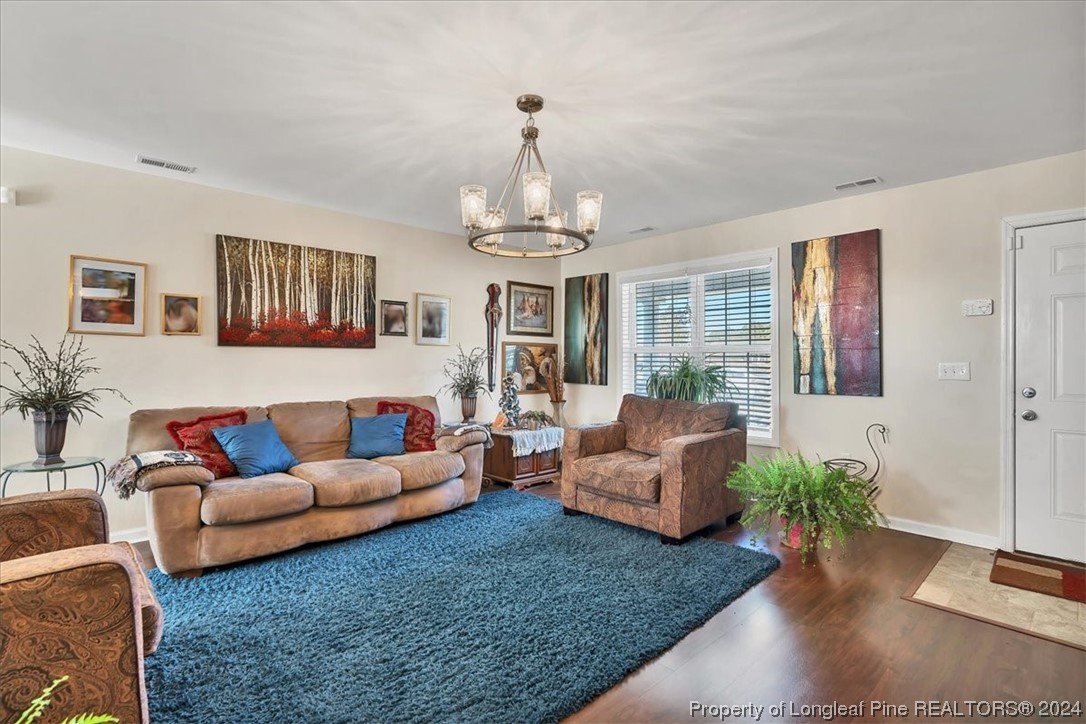 623 Hammonds Road Lumberton, NC 28360 - Photo 15 of 39 a living room with furniture or couch and a chandelier
