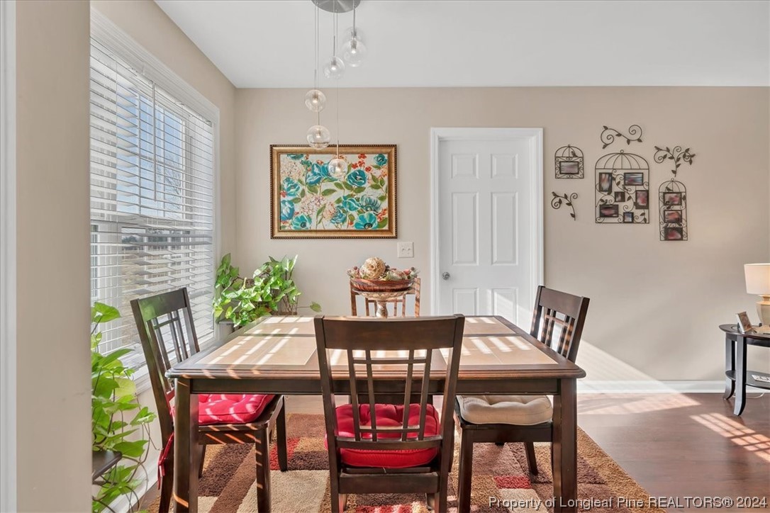 623 Hammonds Road Lumberton, NC 28360 - Photo 19 of 39 a view of a dining room with furniture wooden floor and a chandelier