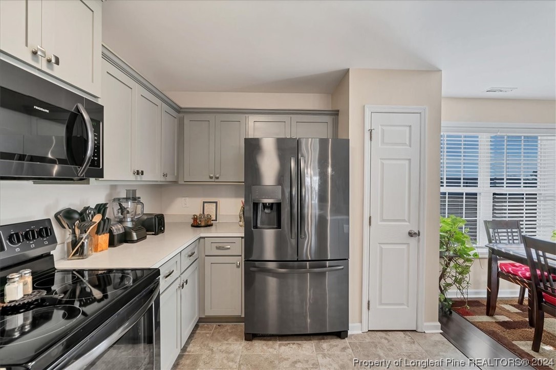 623 Hammonds Road Lumberton, NC 28360 - Photo 24 of 39 a kitchen with a refrigerator stove and cabinets