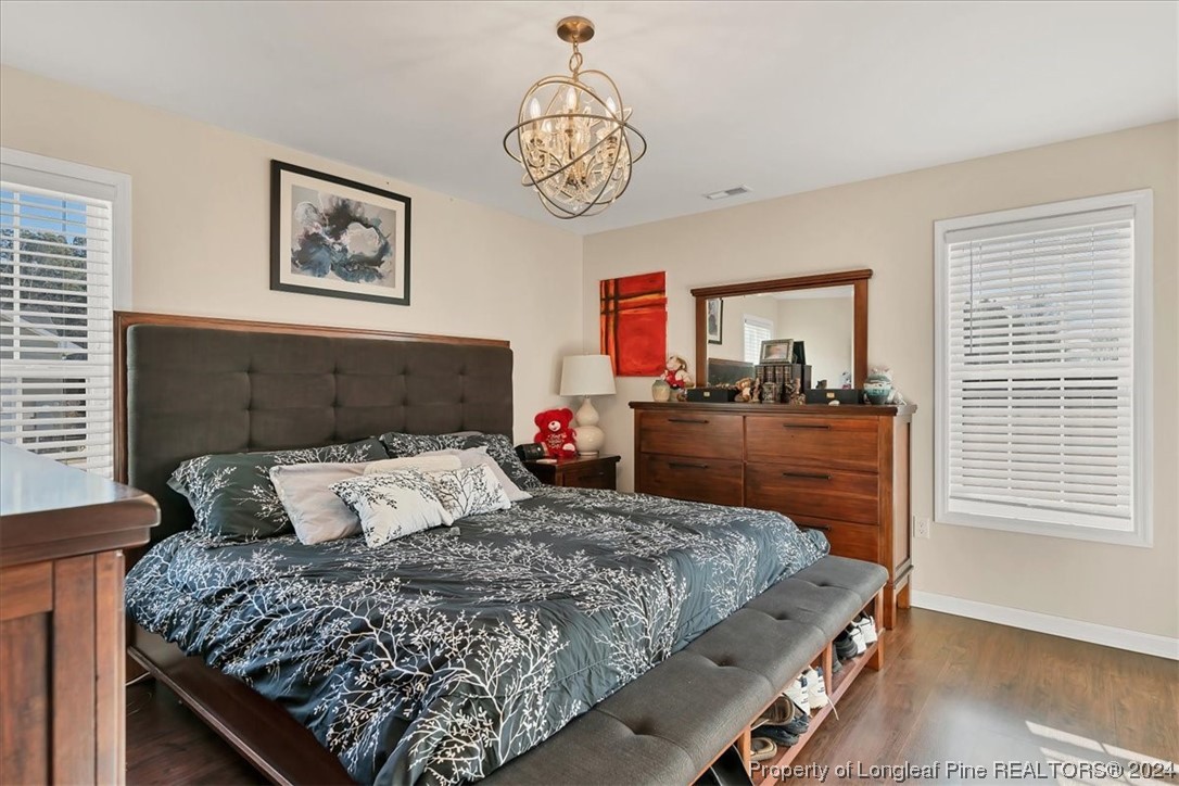 623 Hammonds Road Lumberton, NC 28360 - Photo 27 of 39 a bedroom with a bed and a chandelier