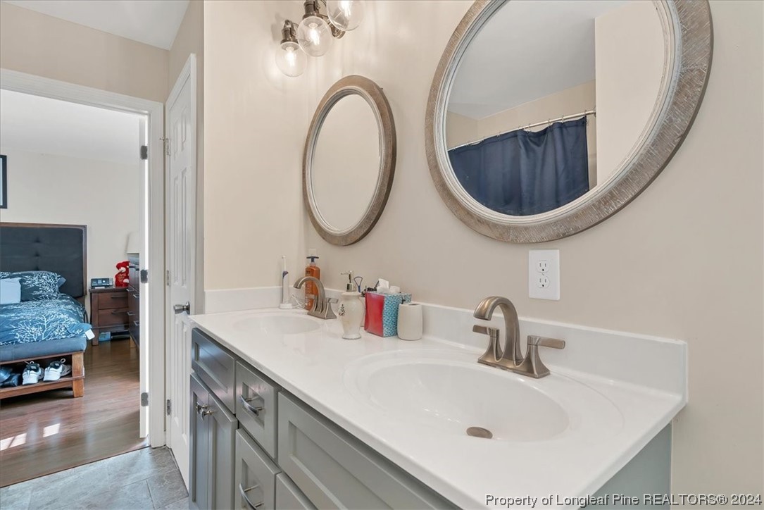 623 Hammonds Road Lumberton, NC 28360 - Photo 33 of 39 a bathroom with a sink and a mirror