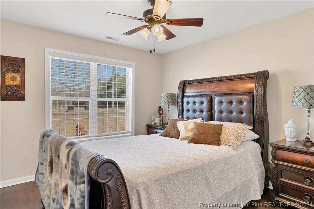 623 Hammonds Road Lumberton, NC 28360 - Photo 37 of 39 a bedroom with a large bed and a chandelier