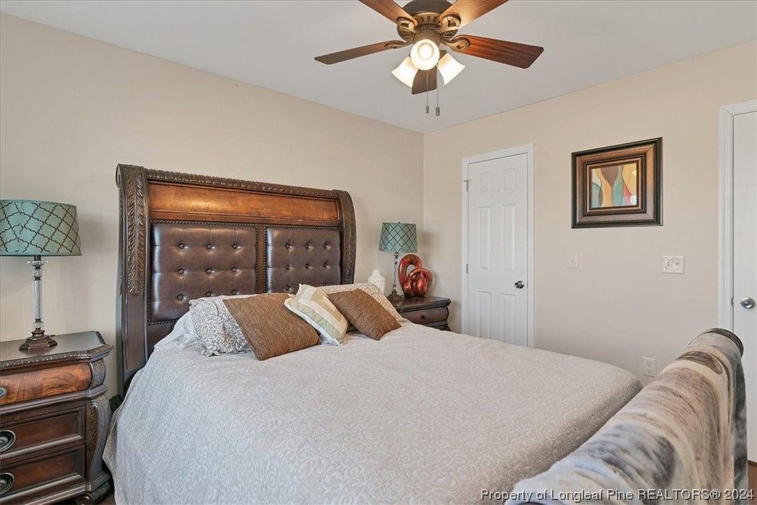 623 Hammonds Road Lumberton, NC 28360 - Photo 38 of 39 a bedroom with a large bed and a lamp