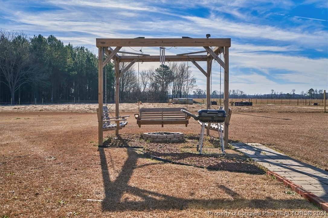 623 Hammonds Road Lumberton, NC 28360 - Photo 10 of 39 a view of a lake with a table chairs and wooden fence