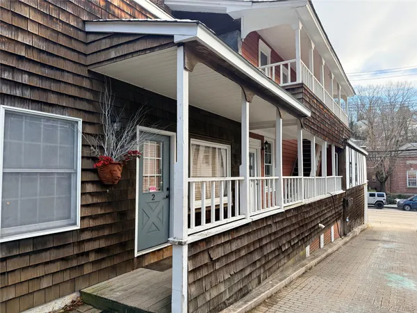 a view of a house with a small yard