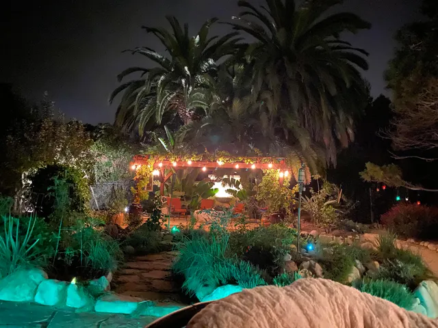 a view of a yard of a house with a swimming pool and outdoor seating