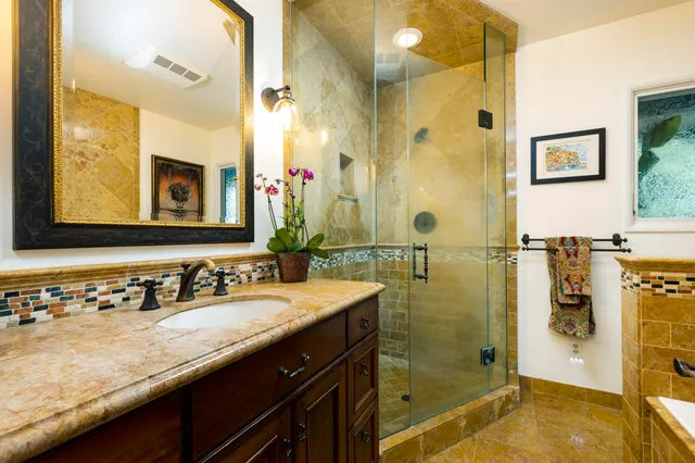 a bathroom with a granite countertop sink mirror and double