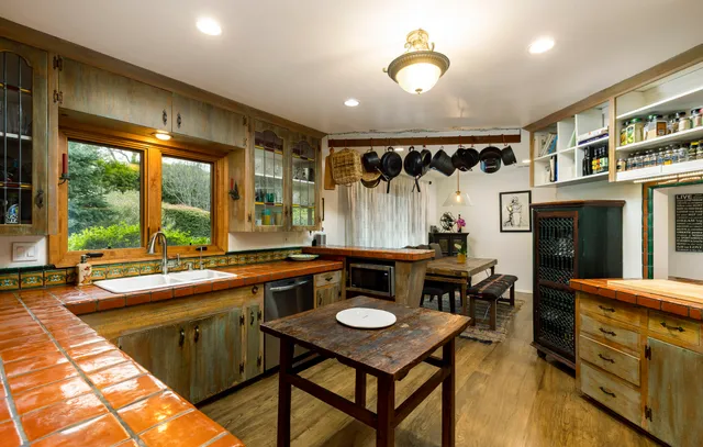 a kitchen that has a table and chairs in it