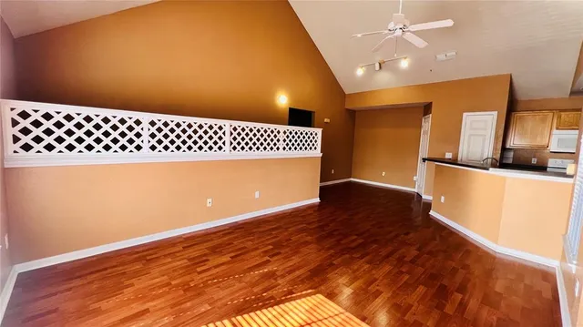 a view of a living room with wooden floor and a window